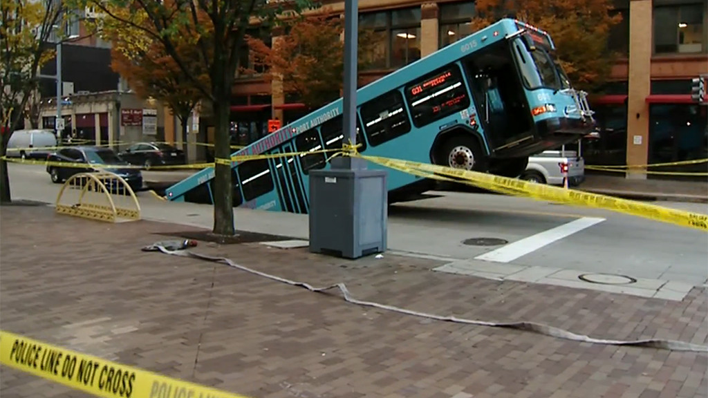 Pittsburgh city bus sinking into the street