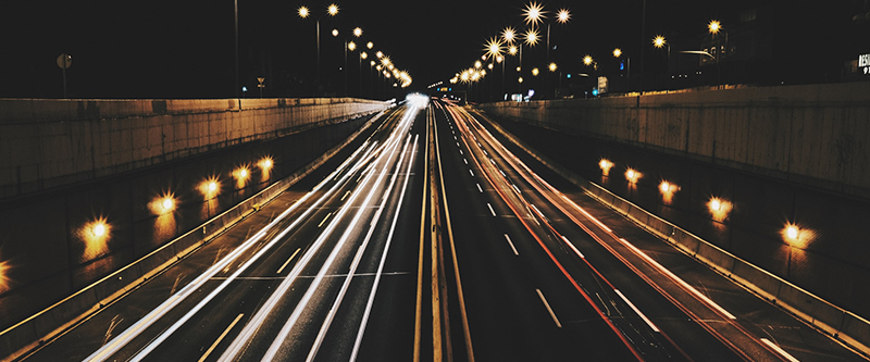 long exposure of cars driving on a dark highway